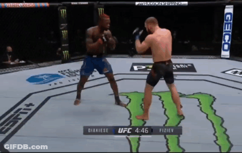 Two Men Fighting In UFC Ring With Monster GIF
