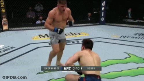 Two Men Fighting Monster In Boxing Ring GIF