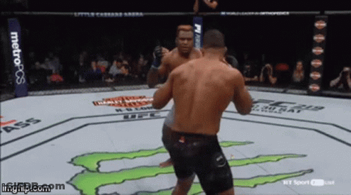 Two Men Fighting Monster On Ground GIF