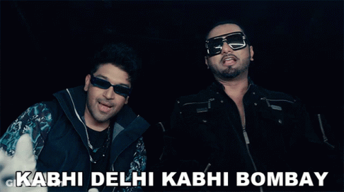 Two Men Giving A Thumbs Up With The Words Kabhi Delhi Kabhi Bombay In The Background GIF