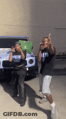 Two Men Giving Middle Finger In Front Of Blue Jeep GIF