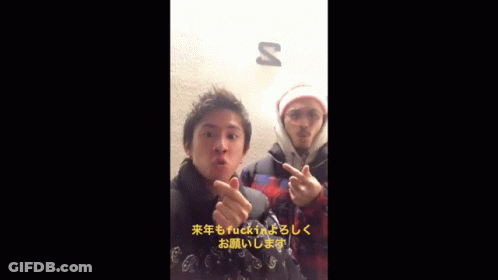 Two Men Giving The Middle Finger In Front Of A Sign That Says S GIF