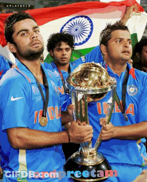 Two Men Holding A Trophy With The Word India On Their Jerseys GIF