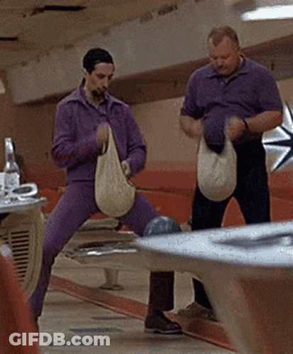Two Men Holding Bags At Bowling Alley GIF