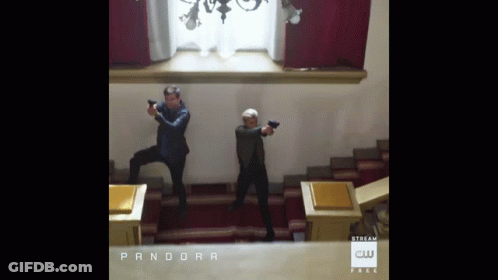Two Men Holding Guns In Room Saying Pandora GIF