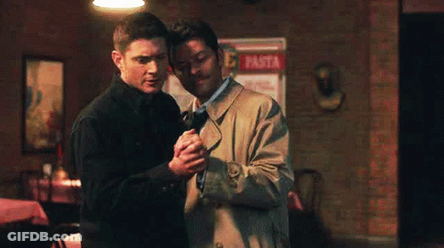 Two Men Holding Hands In Restaurant GIF