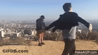 Two Men Holding Hands On Hilltop GIF