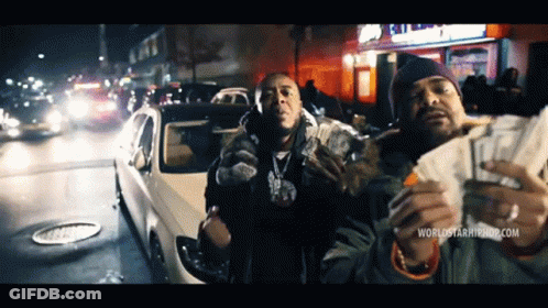 Two Men Holding Money In Front Of A Car With The Website Worldstarhiphop.com Visible GIF