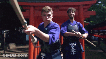 Two Men Holding Swords In Front Of Red Torii Gate With Daniel On Apron GIF