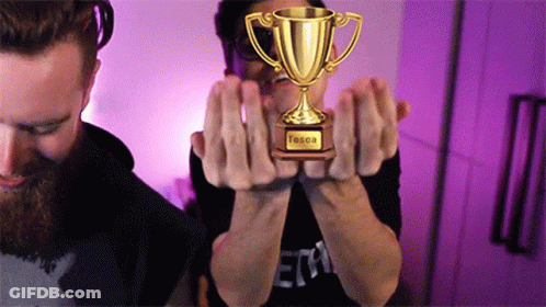 Two Men Holding Tessa Trophy GIF