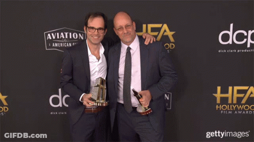 Two Men Holding Trophies Aviation And American Gin GIF