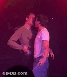 Two Men Hugging And Kissing On Stage GIF