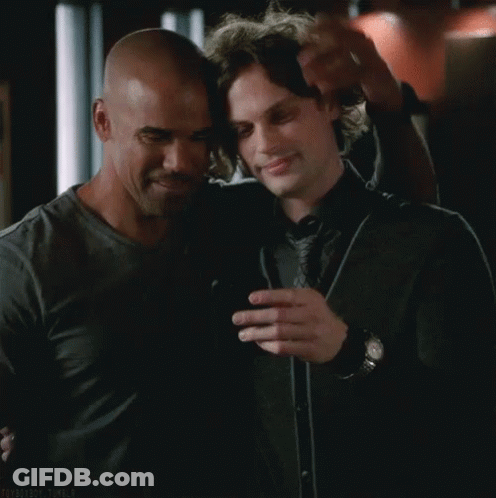 Two Men Hugging And Looking At Cell Phone GIF