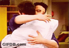 Two Men Hugging Each Other With A White Pillow GIF