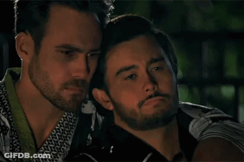 Two Men Hugging In Dark Room GIF