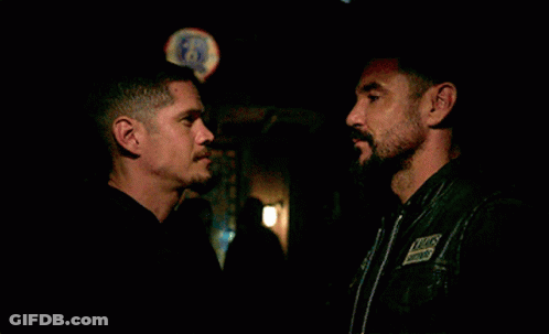 Two Men Hugging In Front Of Bud Light Sign GIF