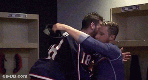 Two Men Hugging In Locker Room One Wearing 18 GIF