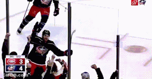 Two Men Hugging In Locker Room, One Wearing Jersey 18 GIF