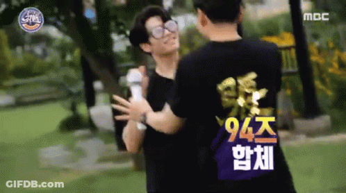 Two Men Hugging In Park, One In 94 Shirt GIF