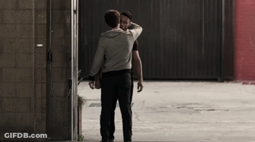 Two Men Hugging In Parking Lot GIF