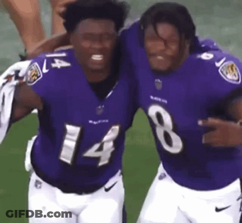 Two Men Hugging In Purple Jerseys GIF