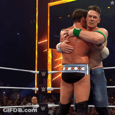 Two Men Hugging In Wrestling Ring With Letter W GIF