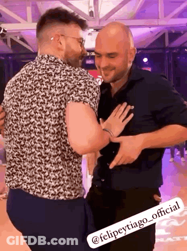 Two Men Hugging On Dance Floor One In Black Shirt GIF