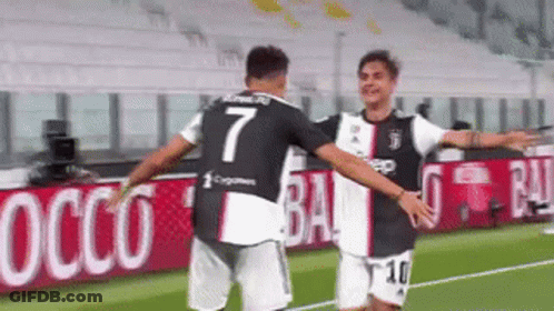 Two Men Hugging On Soccer Field GIF