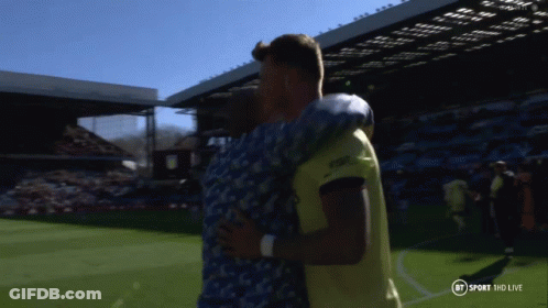 Two Men Hugging On Soccer Field GIF