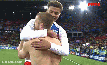 Two Men Hugging On Soccer Field Saying Match GIF
