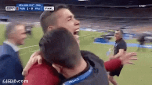 Two Men Hugging On Soccer Field GIF