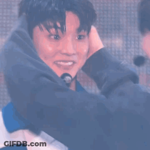 Two Men Hugging On Stage GIF