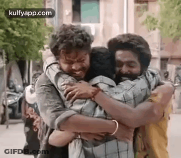 Two Men Hugging On Street GIF