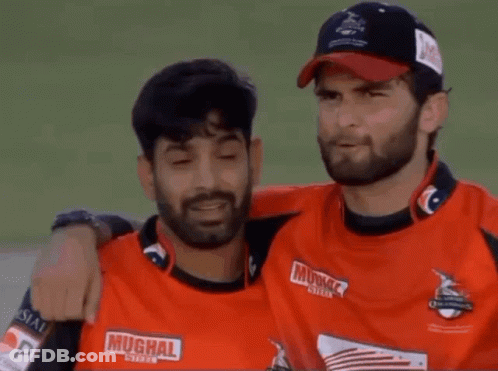 Two Men Hugging One Wearing Muchal Shirt GIF