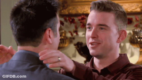 Two Men Hugging One With Ring GIF
