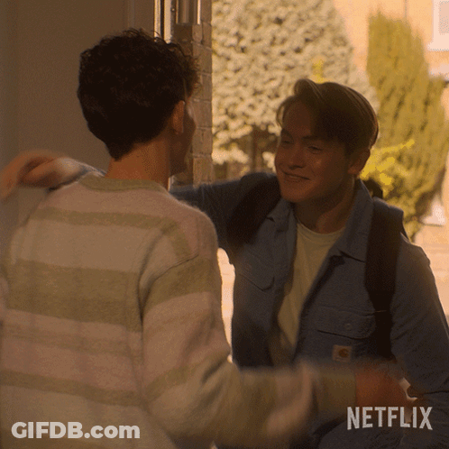 Two Men Hugging With A Netflix Logo Behind Them GIF