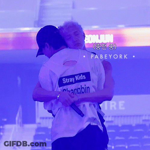 Two Men Hugging With One Wearing A Shirt That Says Stray Kids On It GIF
