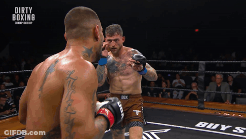 Two Men In A Boxing Ring With Dirty Boxing Championship Written On The Bottom GIF