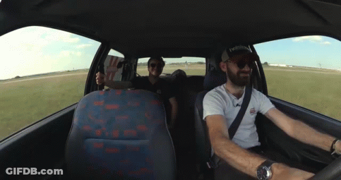 Two Men In A Car With One Wearing A Hat That Says Reebok On It GIF