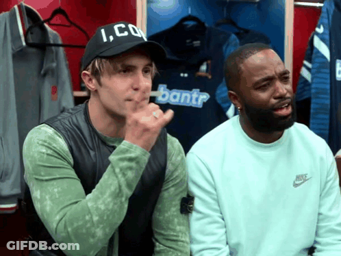 Two Men In A Locker Room One Wearing A Hat That Says Ico GIF
