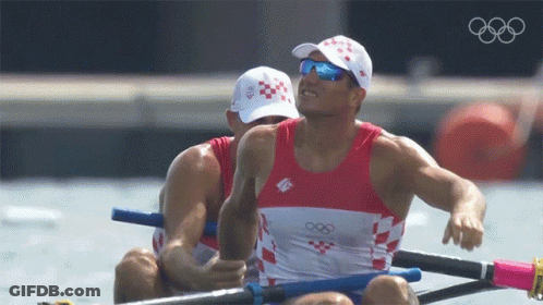 Two Men In A Rowing Boat With The Olympics Logo On The Bottom GIF