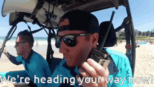 Two Men In A Vehicle With The Words " We 'Re Heading Your Way Now " On The Bottom GIF