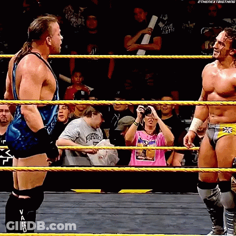 Two Men In A Wrestling Ring One Of Whom Is Wearing A Shirt That Says " I Love Earth " GIF