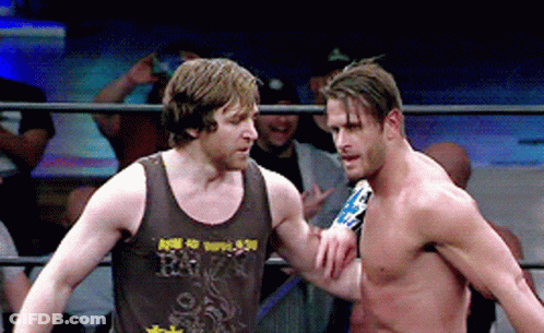 Two Men In A Wrestling Ring One Of Whom Is Wearing A Tank Top That Says R.i.p. GIF