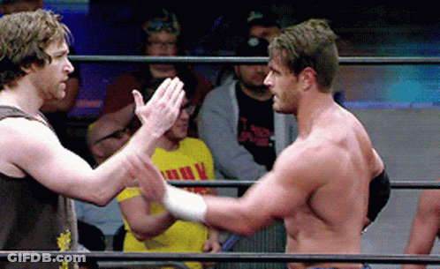 Two Men In A Wrestling Ring One Of Whom Is Wearing A Yellow Shirt That Says ' I Love You ' On It GIF