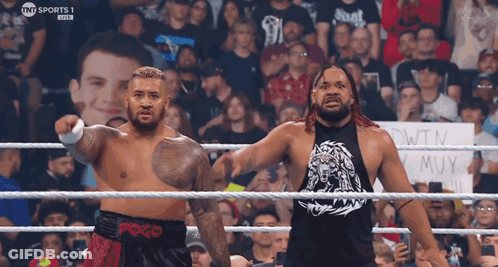 Two Men In A Wrestling Ring With A Sign That Says Tnt Sports 1 Live GIF