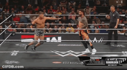 Two Men In A Wrestling Ring With A Sign That Says " Tomorrow " GIF