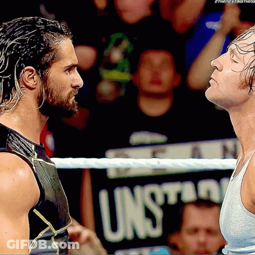 Two Men In A Wrestling Ring With A Sign That Says Unsuitable In The Background GIF