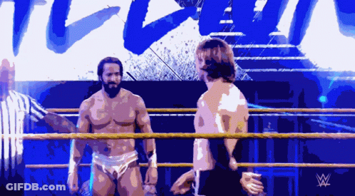 Two Men In A Wrestling Ring With A W Logo On The Bottom Left GIF