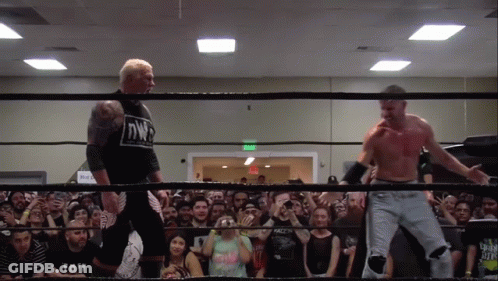 Two Men In A Wrestling Ring With One Wearing A Shirt That Says Nwp On It GIF